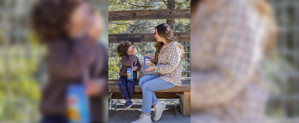 Mom and child sharing a snack featured in a successful influencer campaign, demonstrating authentic brand storytelling through mom creators.”