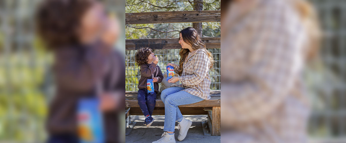 Mom and child sharing a snack featured in a successful influencer campaign, demonstrating authentic brand storytelling through mom creators.” Mom and child sharing a snack featured in a successful influencer campaign, demonstrating authentic brand storytelling through mom creators.”