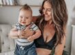 Gen Z parent cradling her happy infant—an authentic image of modern motherhood for brands targeting Gen Z moms.