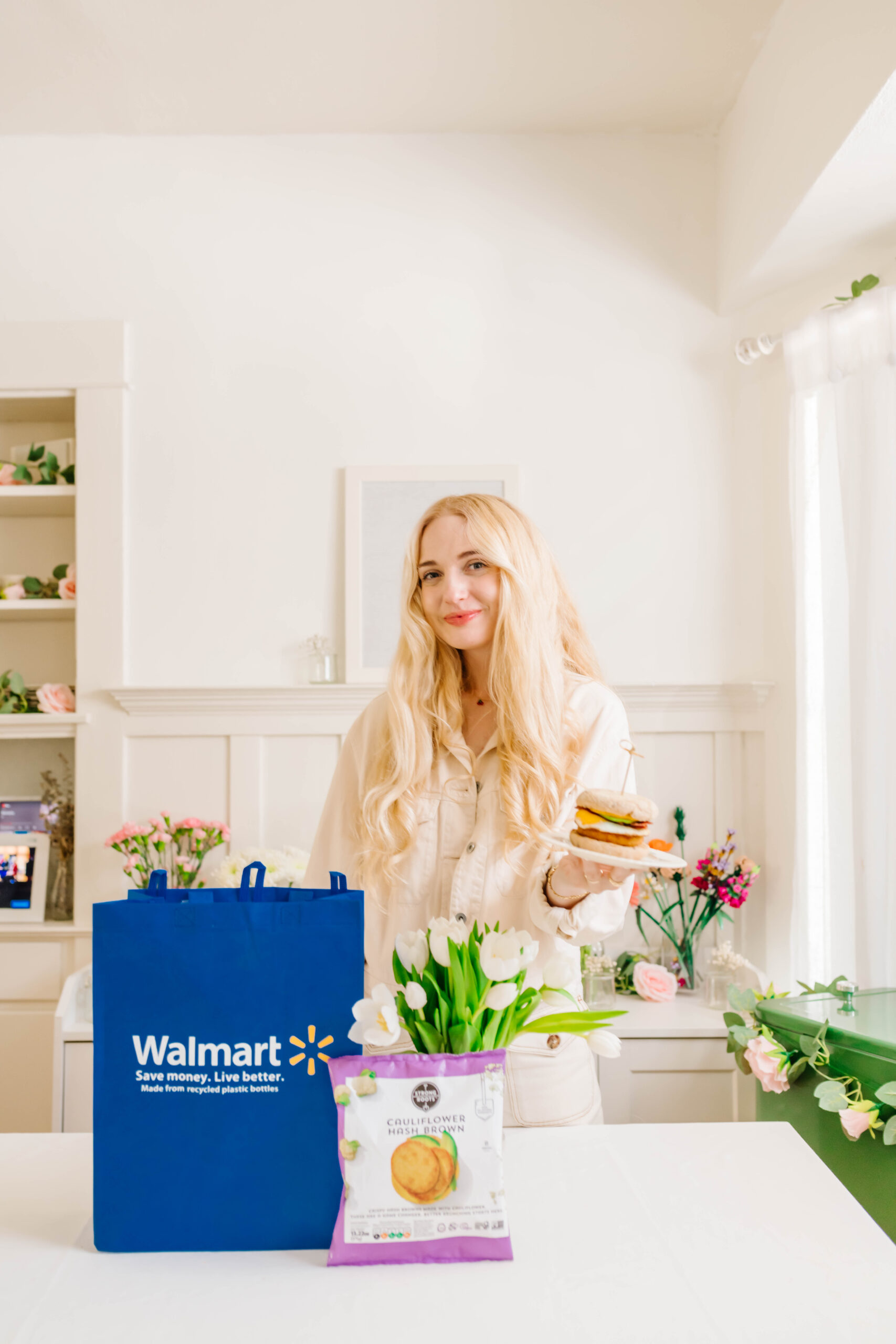 Mom influencer in kitchen displaying sponsored breakfast and Walmart shopping bag, part of a social media brand campaign.