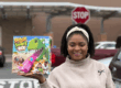 Walmart Mom Influencer shows off her game purchase in front of Walmart Store as part of an influencer campaign.