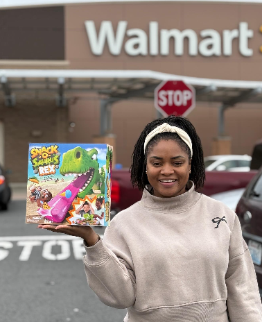 Walmart Mom Influencer shows off her game purchase in front of Walmart Store as part of an influencer campaign.