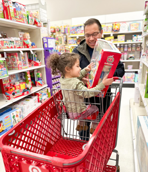 Target Influencer Dad Dad and daughter shopping at Target seeking out toys influencers recommend.