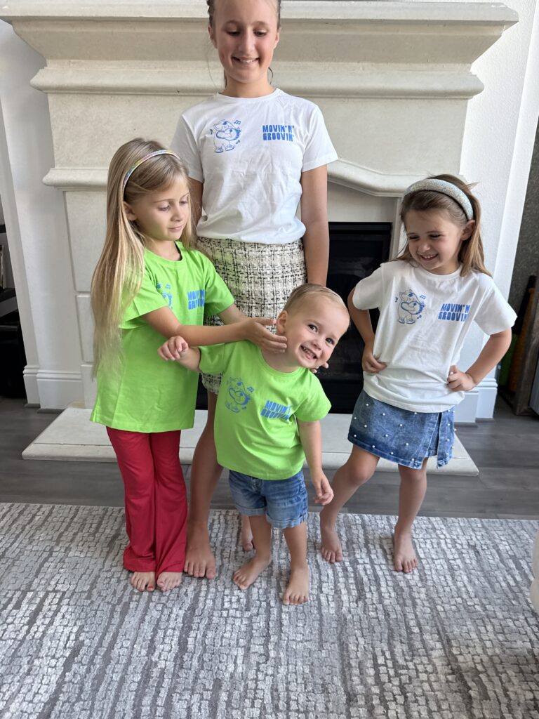 Children of a mom influencer wearing gifted apparel at home, capturing authentic user-generated content from an influencer gifting campaign designed to build trust with moms and Gen Z parents.