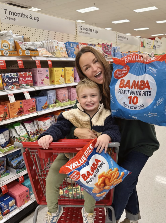 Mom influencer shopping with her child and evaluating a family product in-store, showing how Gen Z moms rely on real-life context and lived experience when making purchase decisions.