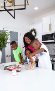 Mom cooking with her children at home, illustrating the kind of real-life parenting moments Gen Z moms discuss and trust when seeking advice on Reddit.