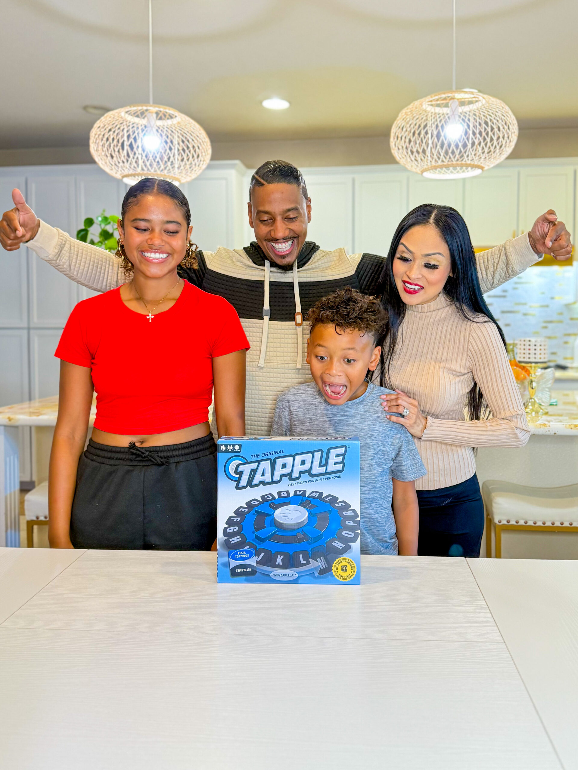 Gen Z parents and kids reacting excitedly to a family word game at home, illustrating authentic family moments and real-life product engagement for marketing to modern parents.