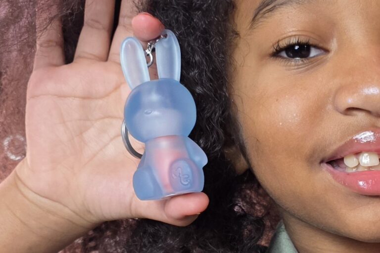 Gen Alpha young girl holding a lipgloss that her Millenial parent bought her.